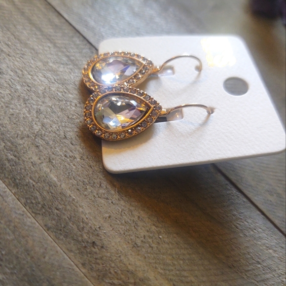 Glass stone teardrop pave clip earrings. Gold toned setting. Length: 1" - Picture 2 of 4
